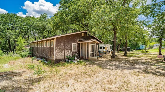 a view of house with yard and sitting area