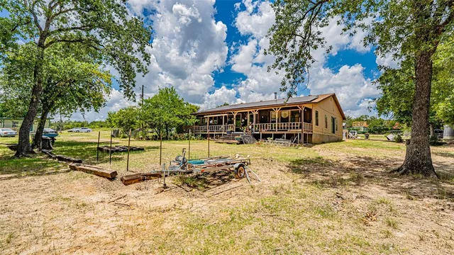 a view of a house with backyard balcony and garden
