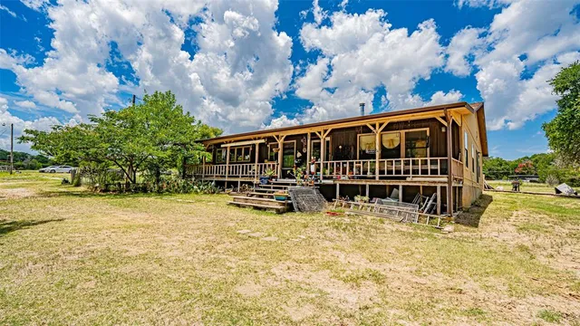 a view of a backyard with swimming pool