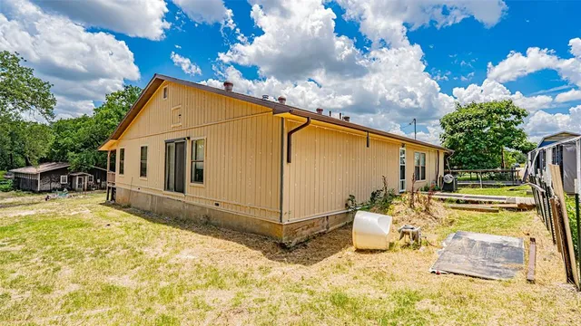 a view of a backyard with a sitting area furniture and garden