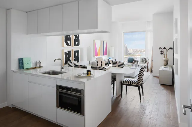 a kitchen with a sink cabinets and wooden floor
