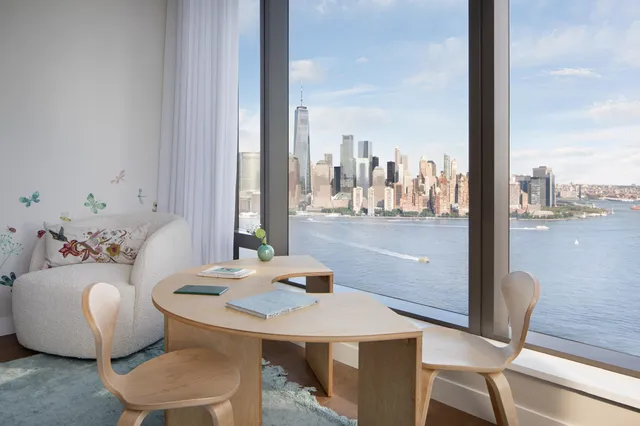 a living room with furniture and a floor to ceiling window