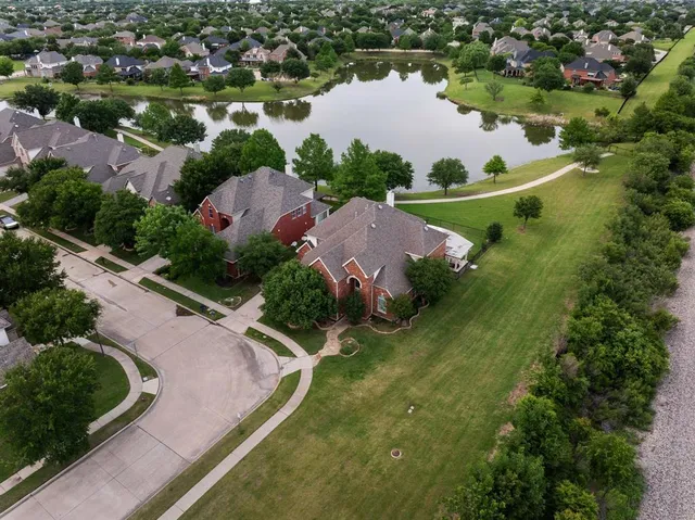 an aerial view of residential houses with outdoor space and street view