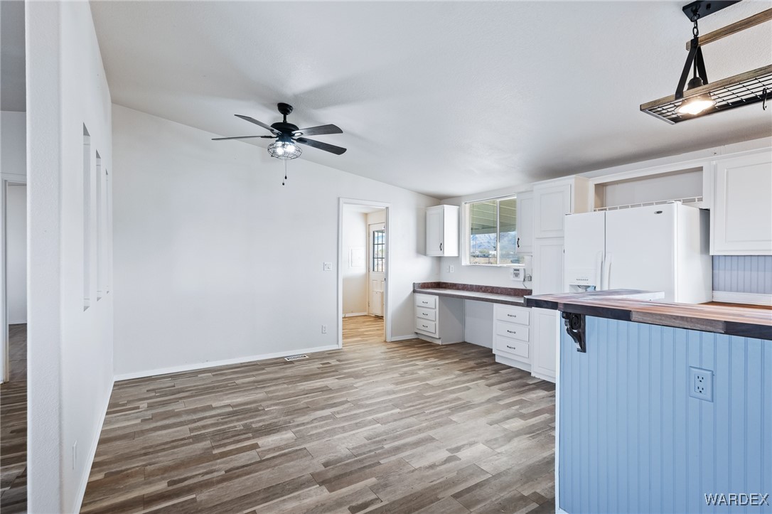 3454 Maverick Road Golden Valley, AZ 86413 - Photo 5 of 18 a kitchen with stainless steel appliances a sink cabinets and wooden floor