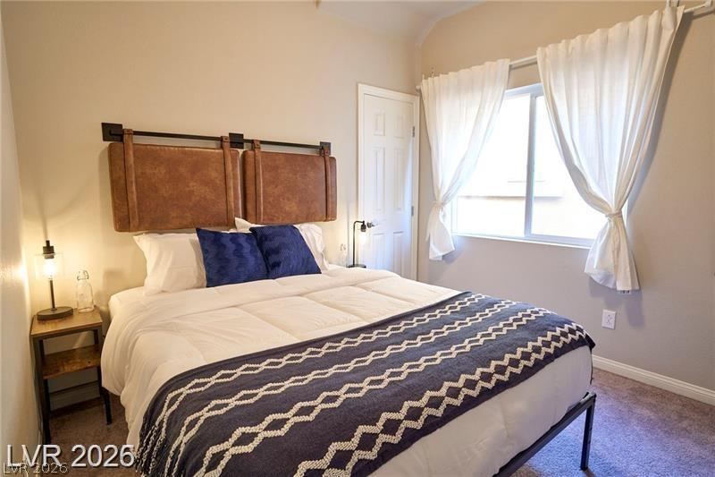 6302 Jackson Spring Road Las Vegas, NV 89118 - Photo 15 of 48 A well-lit bedroom provides a restful retreat, complete with soft carpeting and ample natural light.