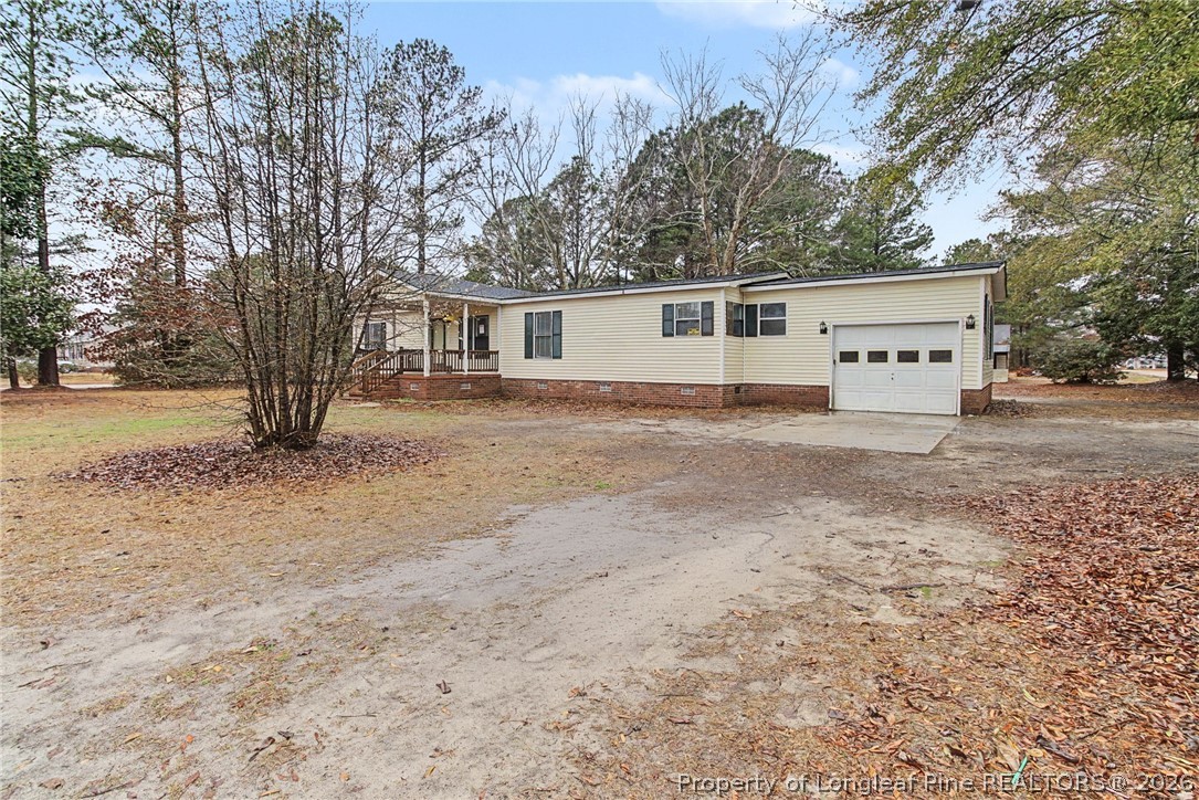 1512 Seabrook School Road Fayetteville, NC 28312 - Photo 3 of 30 a view of a house with a yard and trees