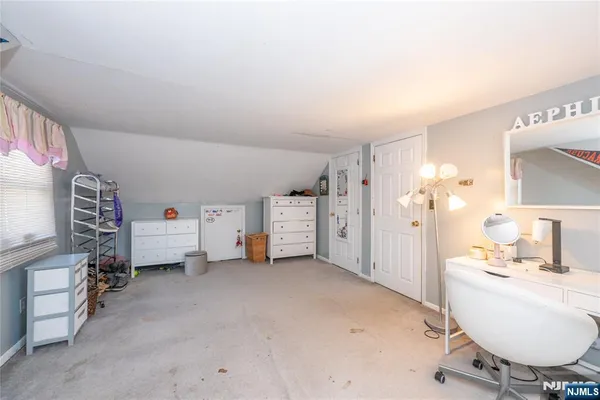 a bedroom with a bed and a chair