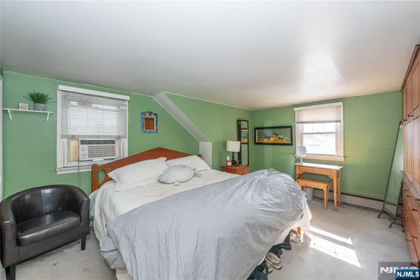 a bedroom with a bed and a dresser