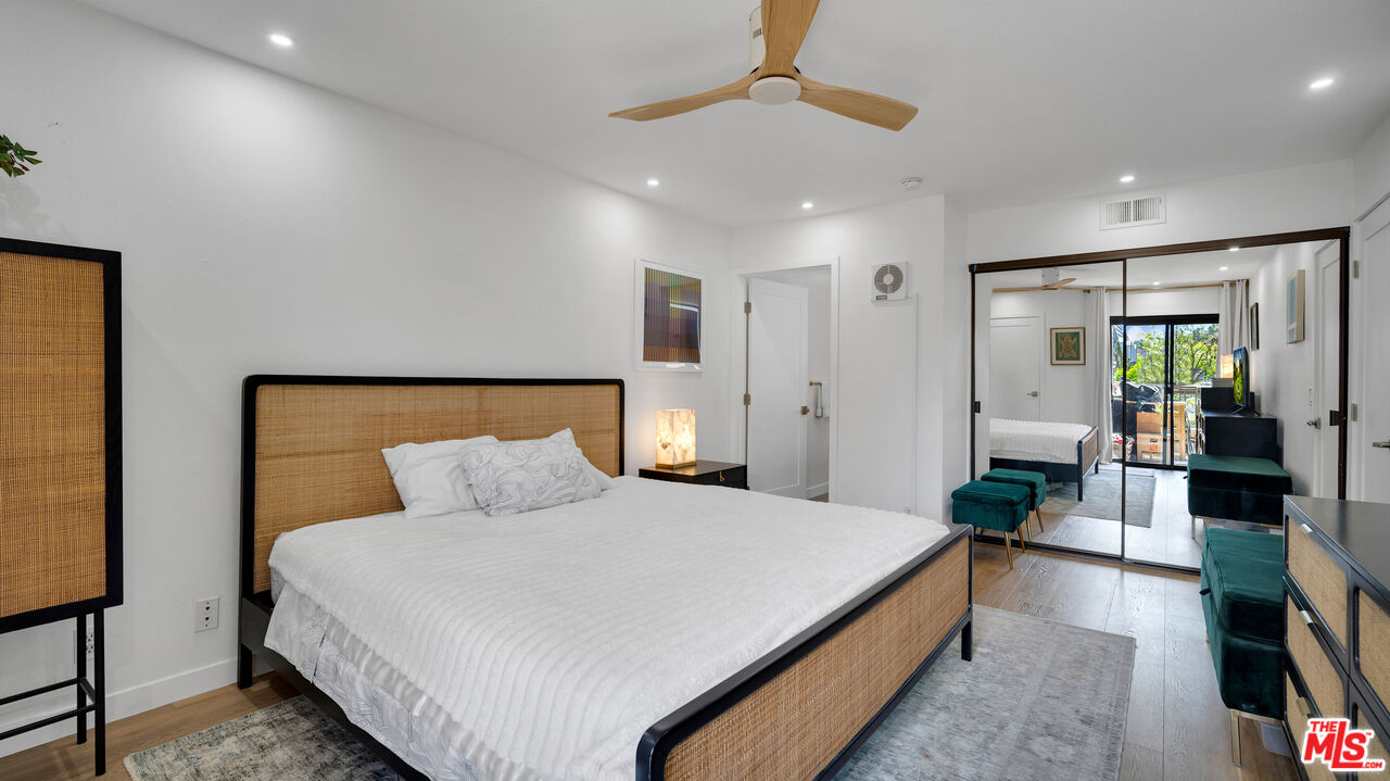 8601 Falmouth Avenue, Unit 224 Playa del Rey, CA 90293 - Photo 15 of 41 a bedroom with bed and a chandelier