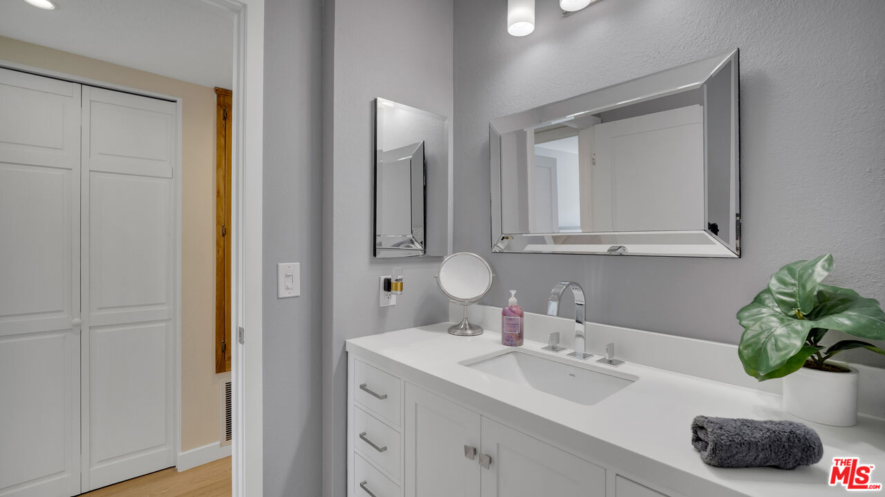 8601 Falmouth Avenue, Unit 224 Playa del Rey, CA 90293 - Photo 26 of 41 a bathroom with a sink a potted plant and a mirror