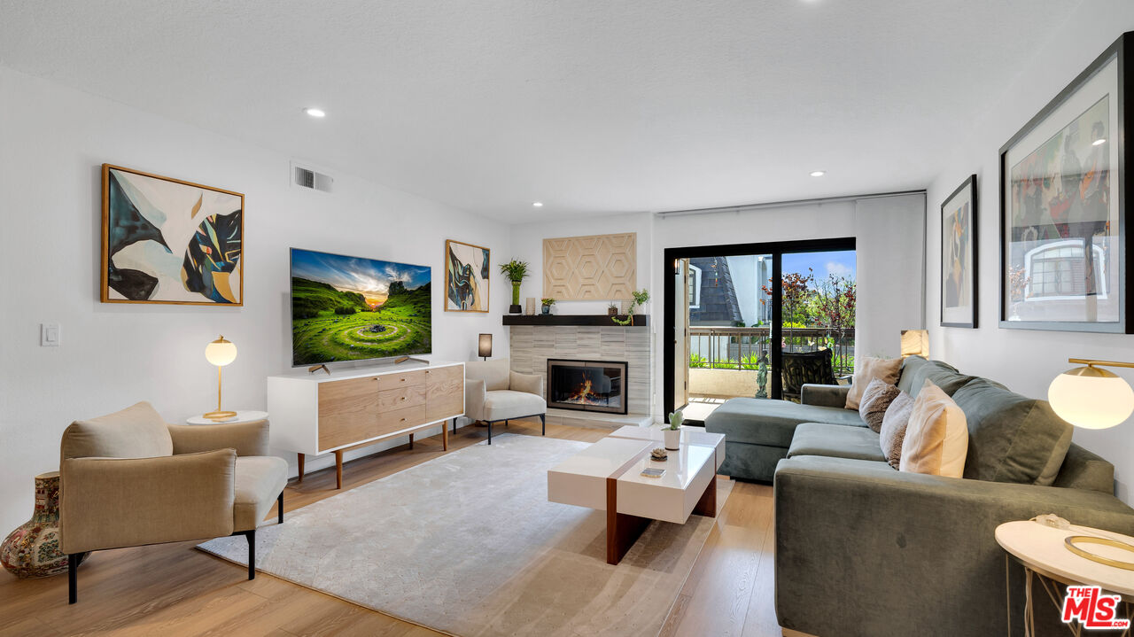 8601 Falmouth Avenue, Unit 224 Playa del Rey, CA 90293 - Photo 3 of 41 a living room with furniture flat screen tv and a fireplace