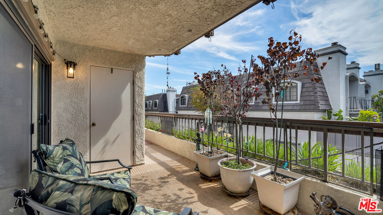 8601 Falmouth Avenue, Unit 224 Playa del Rey, CA 90293 - Photo 35 of 41 a view of a balcony with chair and potted plants