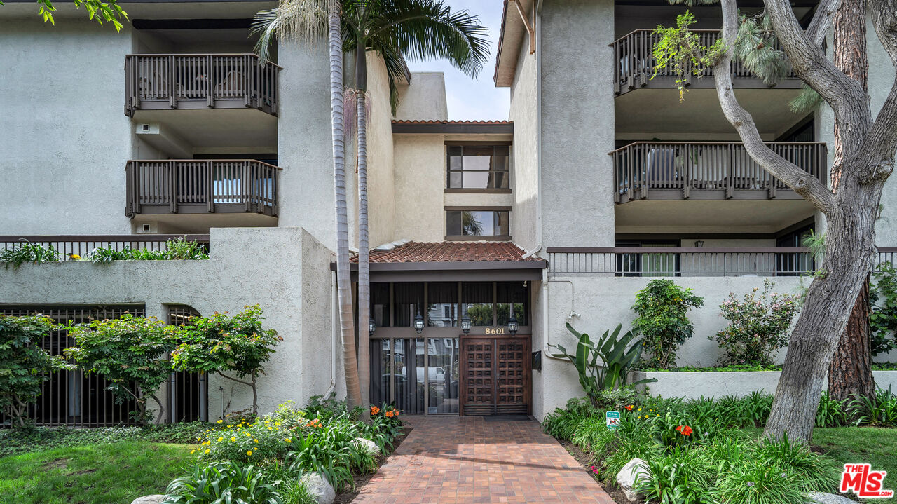 8601 Falmouth Avenue, Unit 224 Playa del Rey, CA 90293 - Photo 36 of 41 a front view of a house with a yard and potted plants