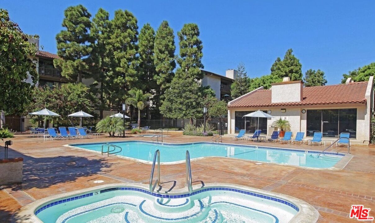 8601 Falmouth Avenue, Unit 224 Playa del Rey, CA 90293 - Photo 37 of 41 a swimming pool with outdoor seating and yard
