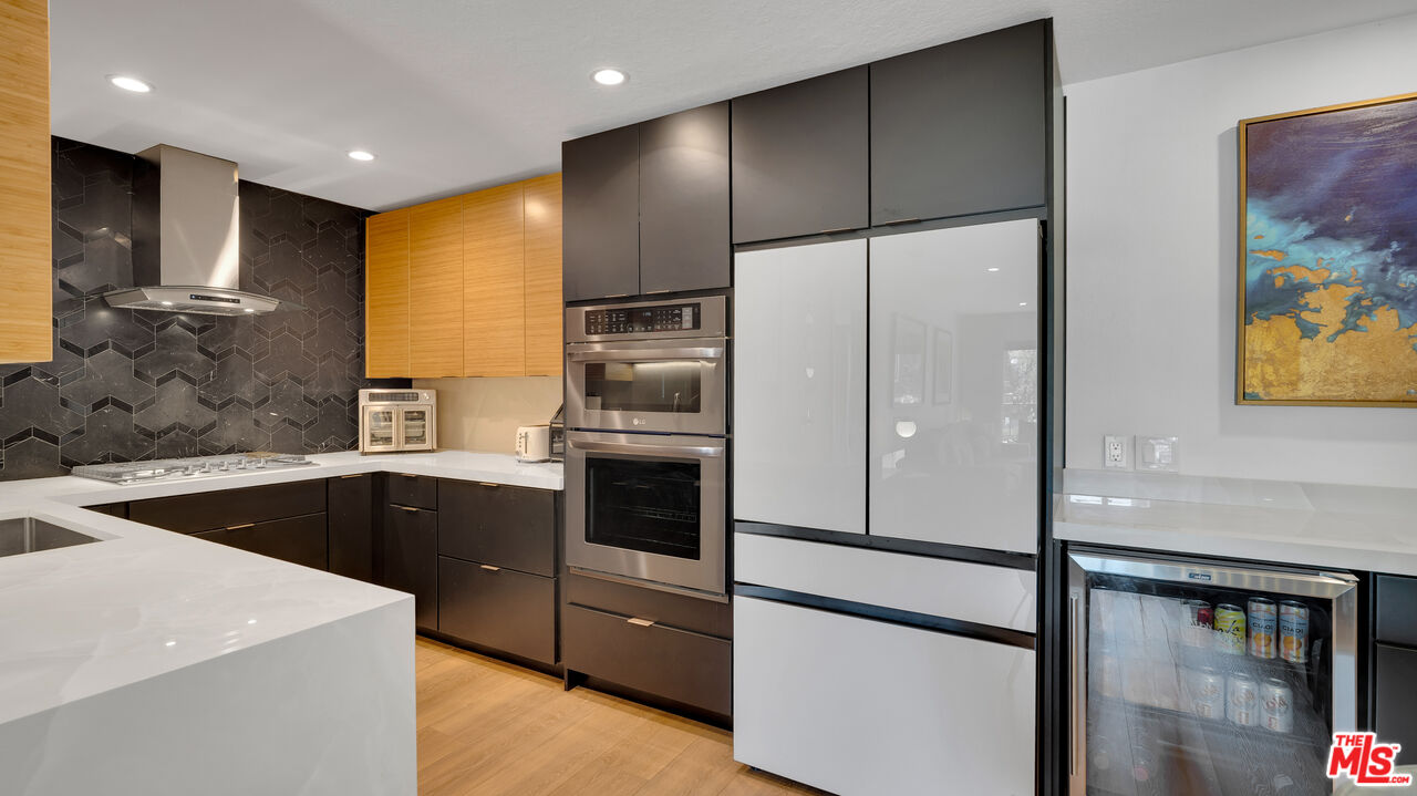 8601 Falmouth Avenue, Unit 224 Playa del Rey, CA 90293 - Photo 9 of 41 a kitchen with a refrigerator sink and cabinets