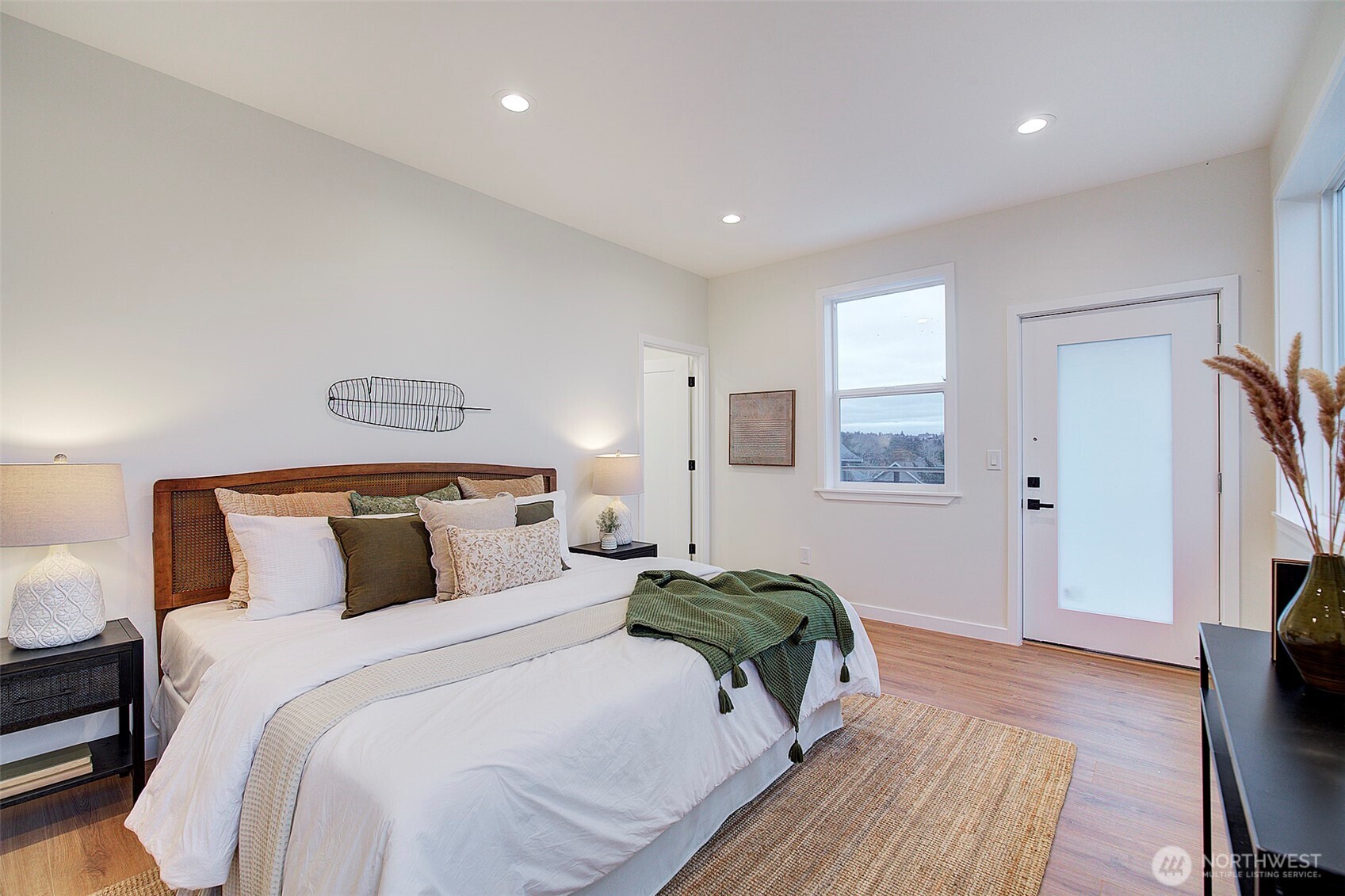 7008 Linden Avenue North Seattle, WA 98103 - Photo 13 of 39 a bedroom with a bed and a flat screen tv