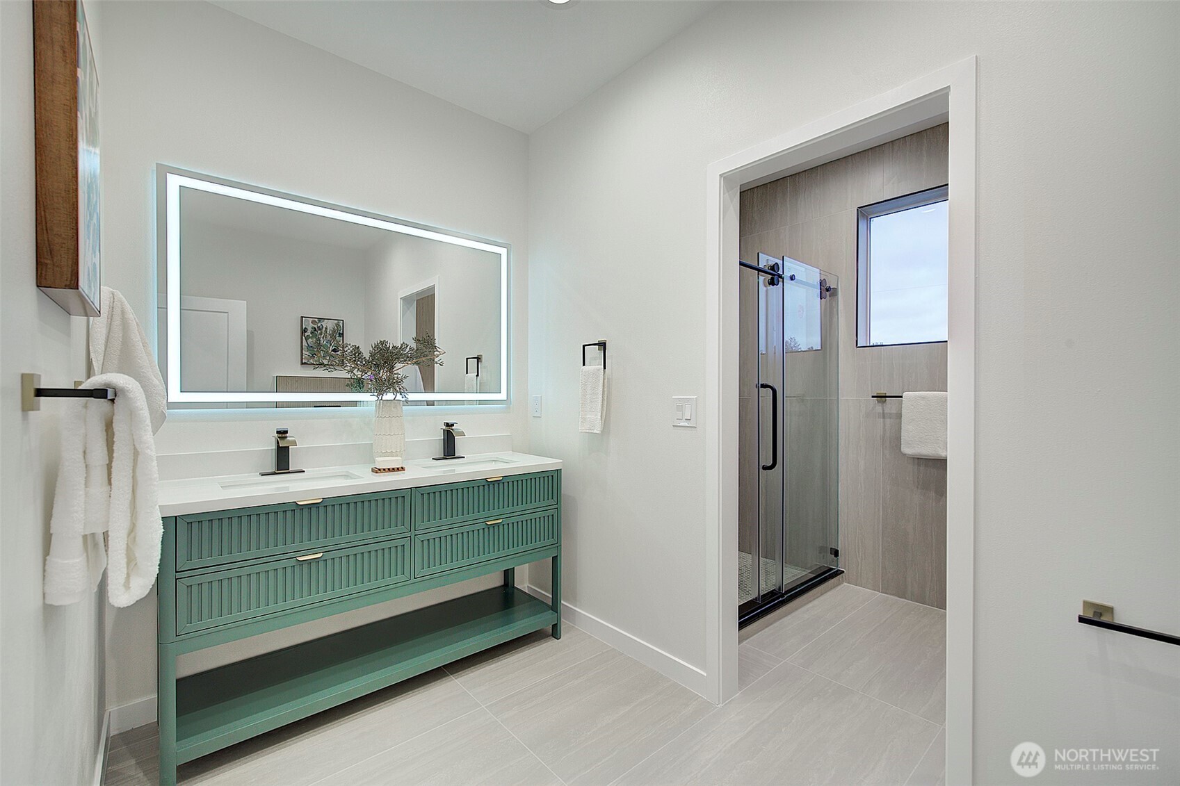 7008 Linden Avenue North Seattle, WA 98103 - Photo 16 of 39 a bathroom with a double vanity sink mirror and bathtub