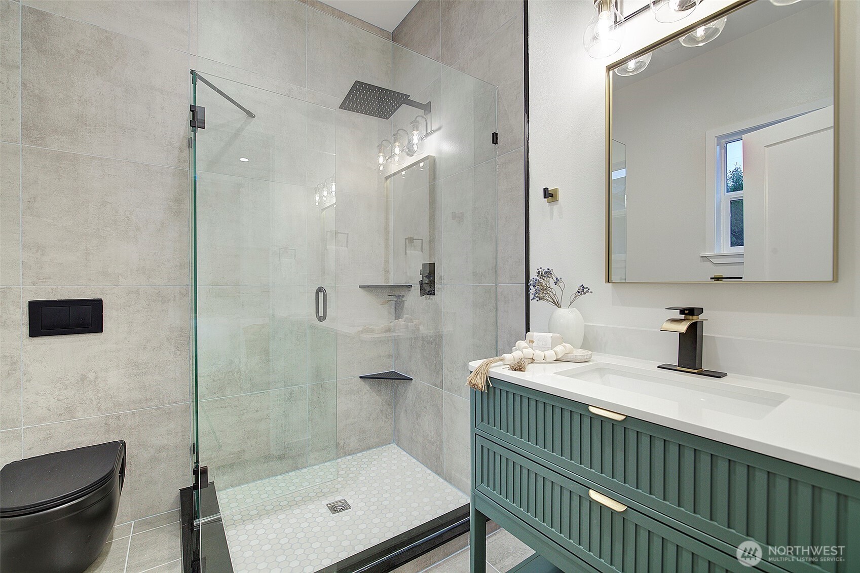 7008 Linden Avenue North Seattle, WA 98103 - Photo 25 of 39 a bathroom with a sink a toilet and shower