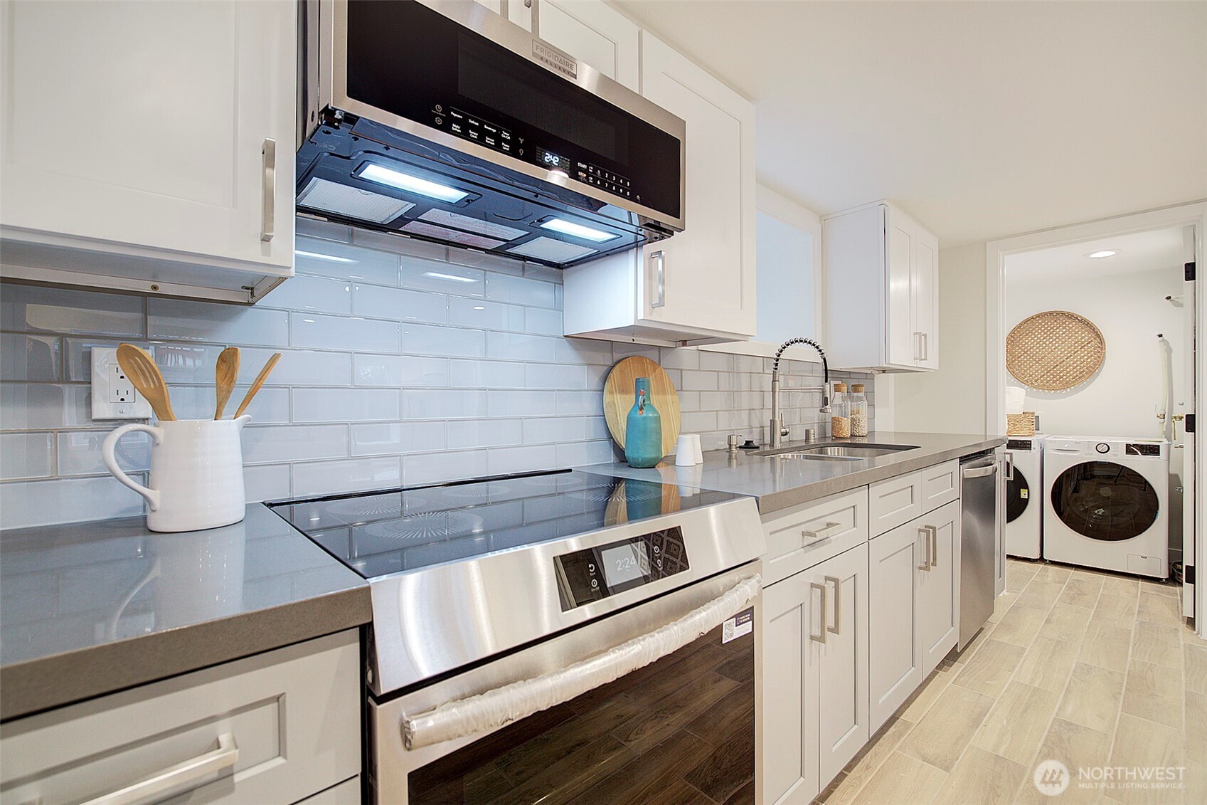7008 Linden Avenue North Seattle, WA 98103 - Photo 26 of 39 a kitchen with stainless steel appliances granite countertop a sink and cabinets