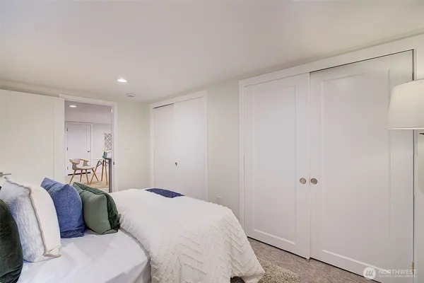 a bedroom with a bed and a lamp