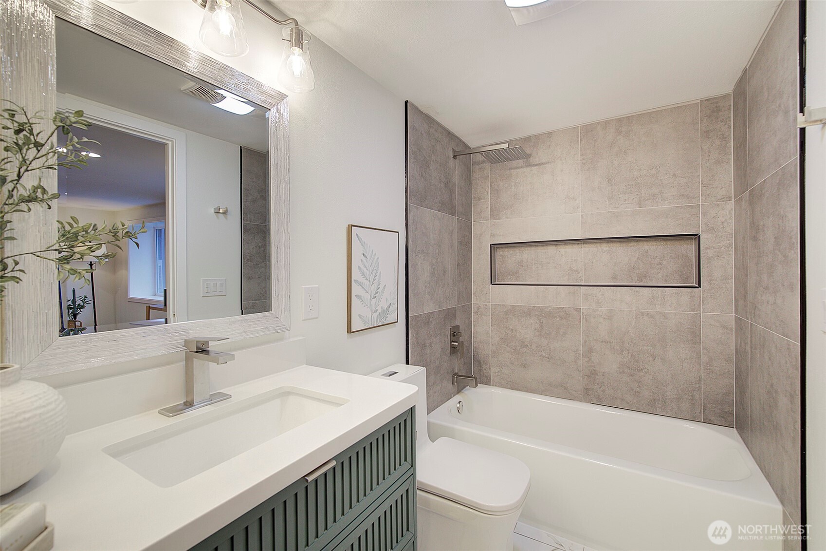 7008 Linden Avenue North Seattle, WA 98103 - Photo 35 of 39 a bathroom with a sink a mirror and a bathtub