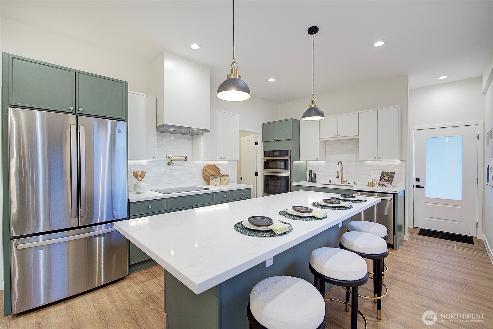 7008 Linden Avenue North Seattle, WA 98103 - Photo 7 of 39 a kitchen with stainless steel appliances granite countertop a sink a stove a refrigerator and chairs