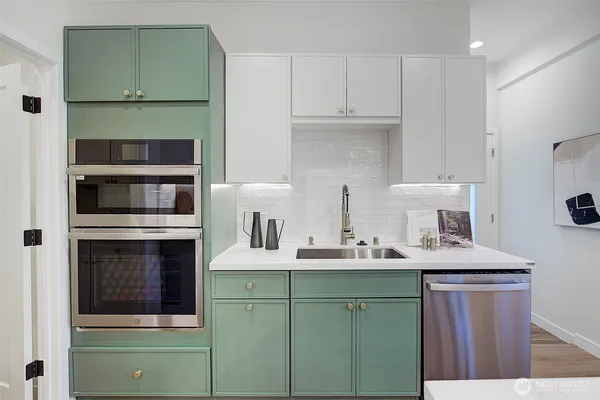 a kitchen with stainless steel appliances granite countertop a sink and cabinets
