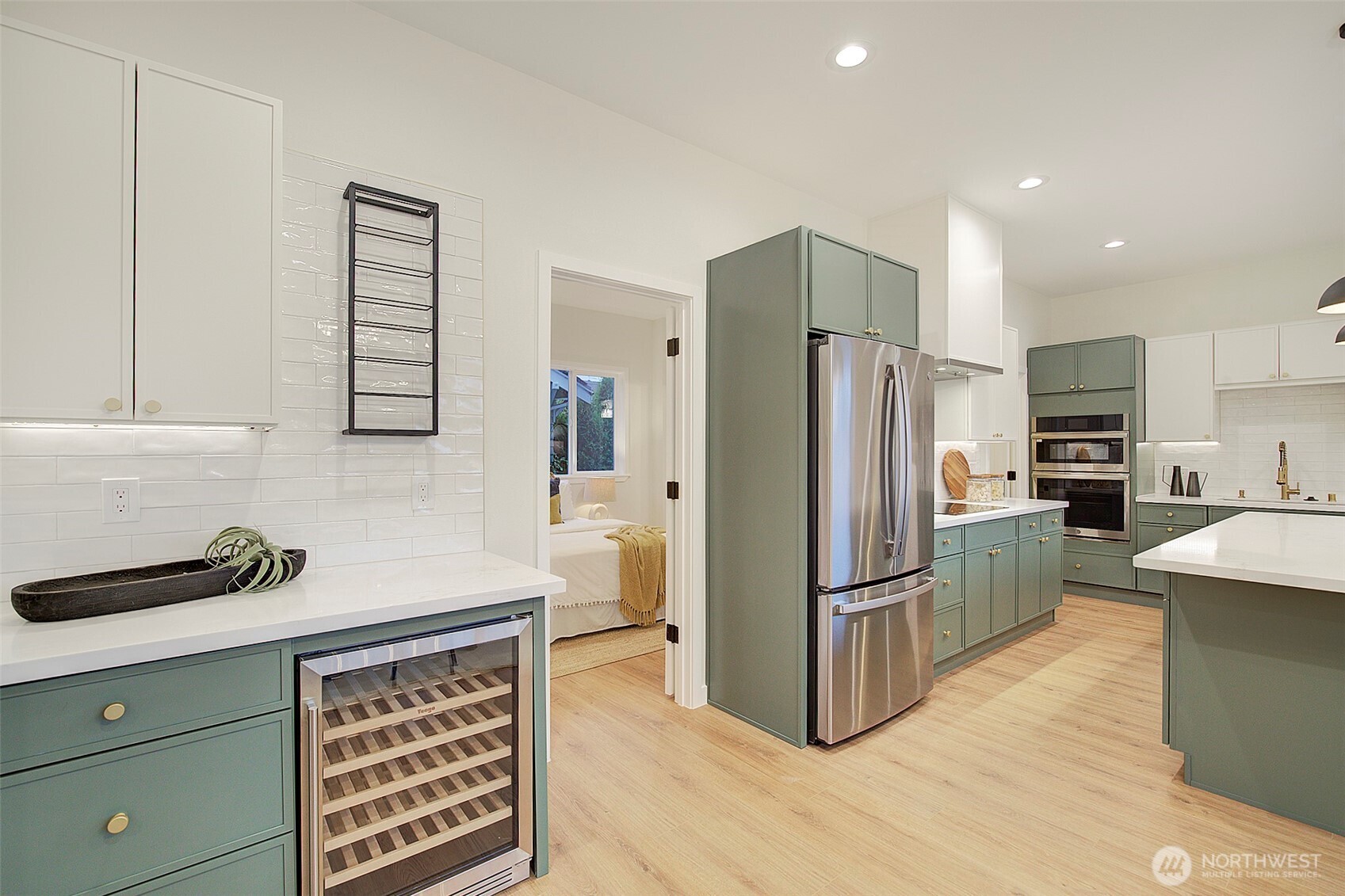 7008 Linden Avenue North Seattle, WA 98103 - Photo 10 of 39 a kitchen with granite countertop a refrigerator and a stove top oven