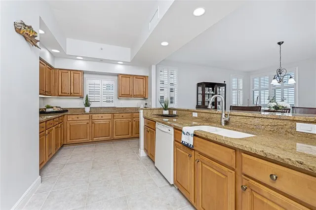 a kitchen with granite countertop sink stainless steel appliances and white cabinets