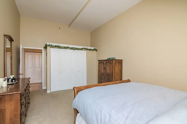 a bedroom with a bed and a mirror