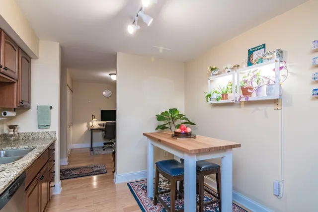 a kitchen with granite countertop a table chairs stove and cabinets