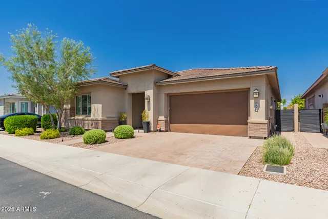a front view of a house with a yard and a garage