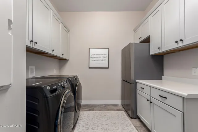 a view of a storage and utility room with washer and dryer