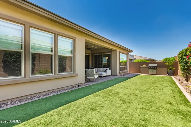 a view of a house with backyard porch and sitting area