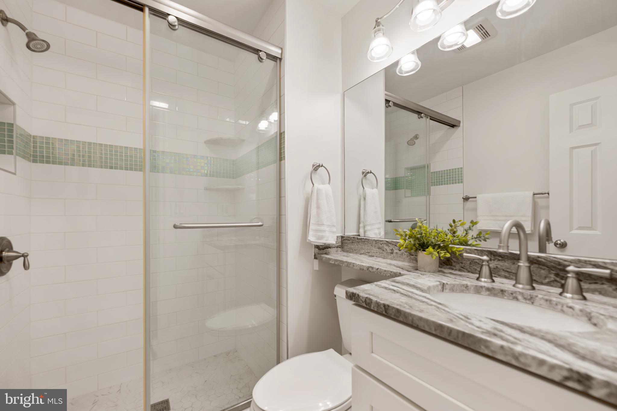 6800 Seton Court Springfield, VA 22152 - Photo 22 of 51 a bathroom with a granite countertop sink toilet and shower