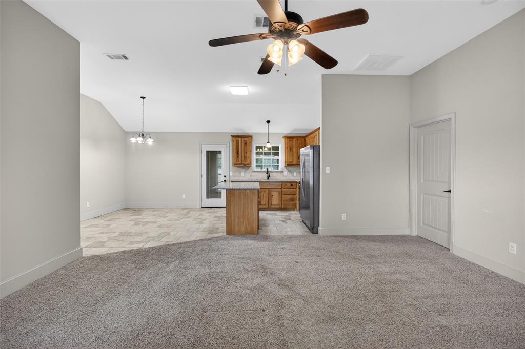 505 East 5th Street Springtown, TX 76082 - Photo 5 of 39 a view of a kitchen with a sink and a ceiling fan