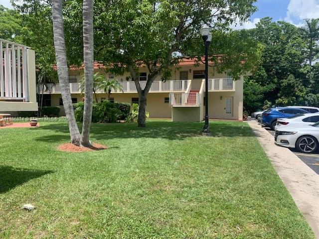 14901 Southwest 4th Street, Unit 9A Pembroke Pines, FL 33027 - Photo 5 of 6 a front view of a house with a yard and trees