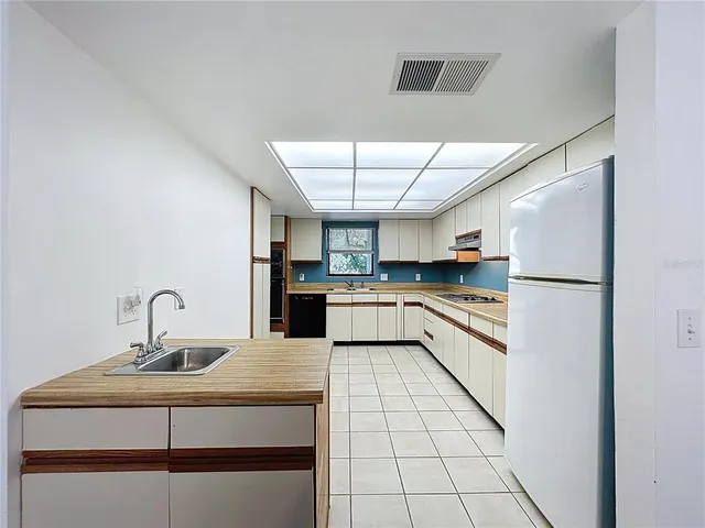 a view of a livingroom with a table and a chandelier