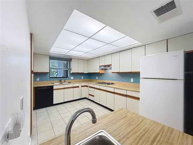 a view of a big room with windows and fireplace