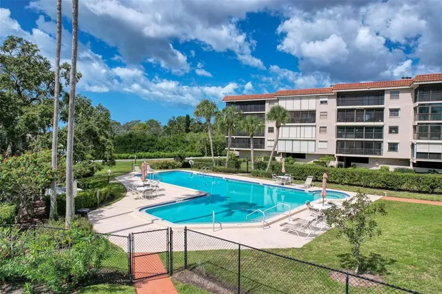 an aerial view of lake and residential houses with outdoor space