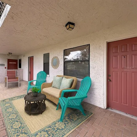 a view of a hallway to an empty room with window