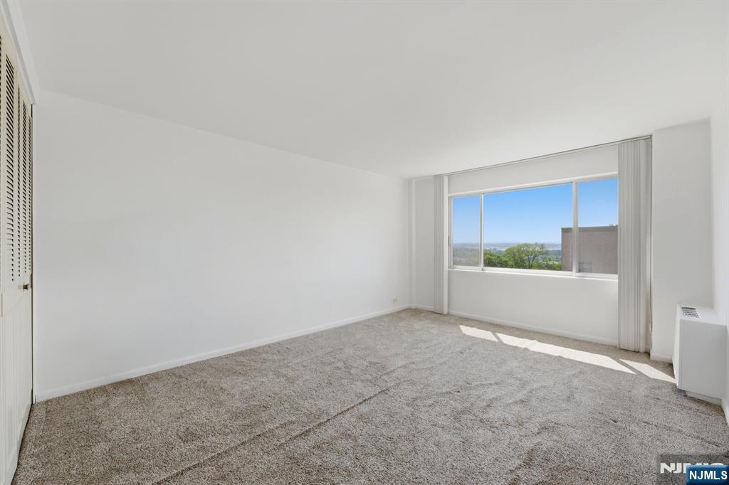 265 Main Street, Unit 704 Ridgefield Park, NJ 07660 - Photo 14 of 23 a view of an empty room with a window