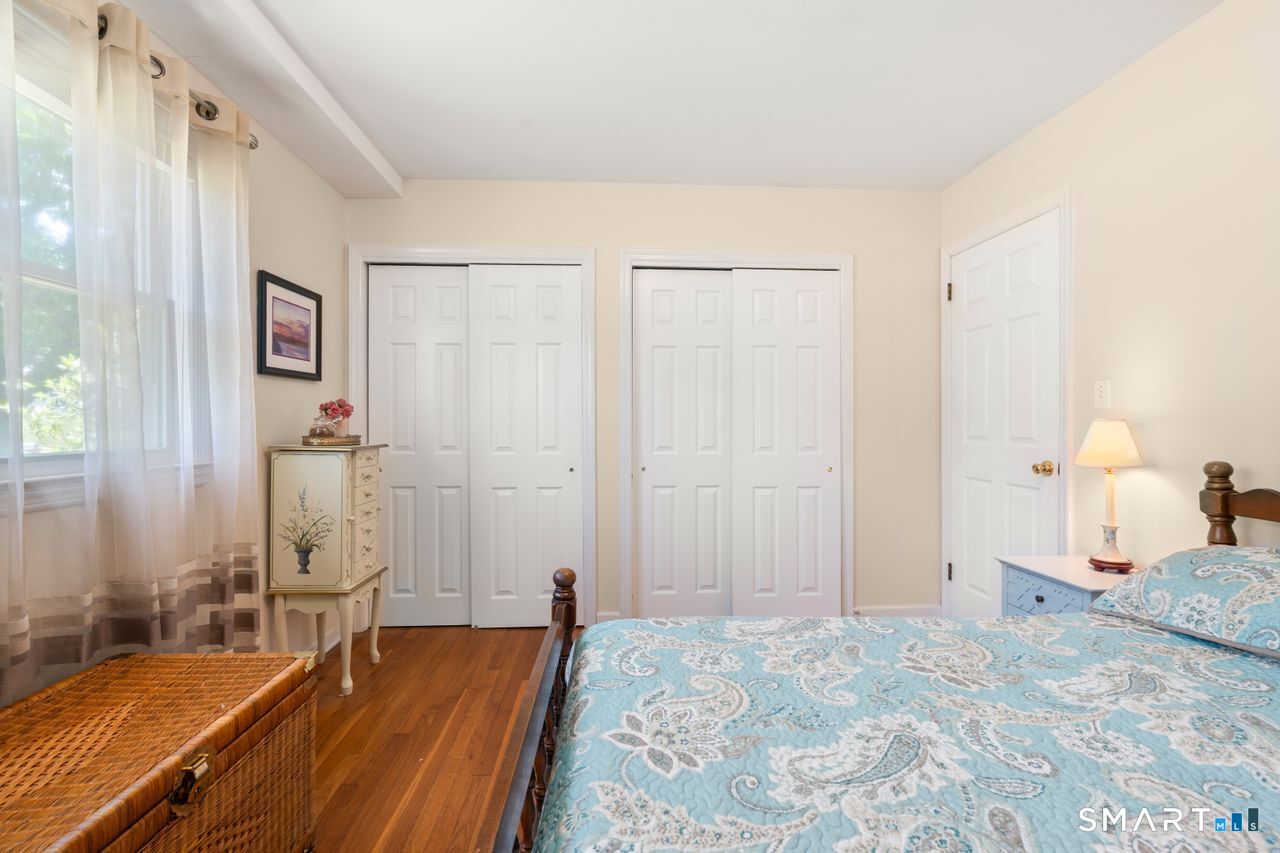 9 Stanton Road North Haven, CT 06473 - Photo 18 of 35 a bedroom with a bed and a chandelier