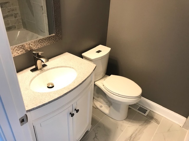 125 Red Barn Road Matteson, IL 60443 - Photo 14 of 14 a white toilet sitting next to a bathroom sink
