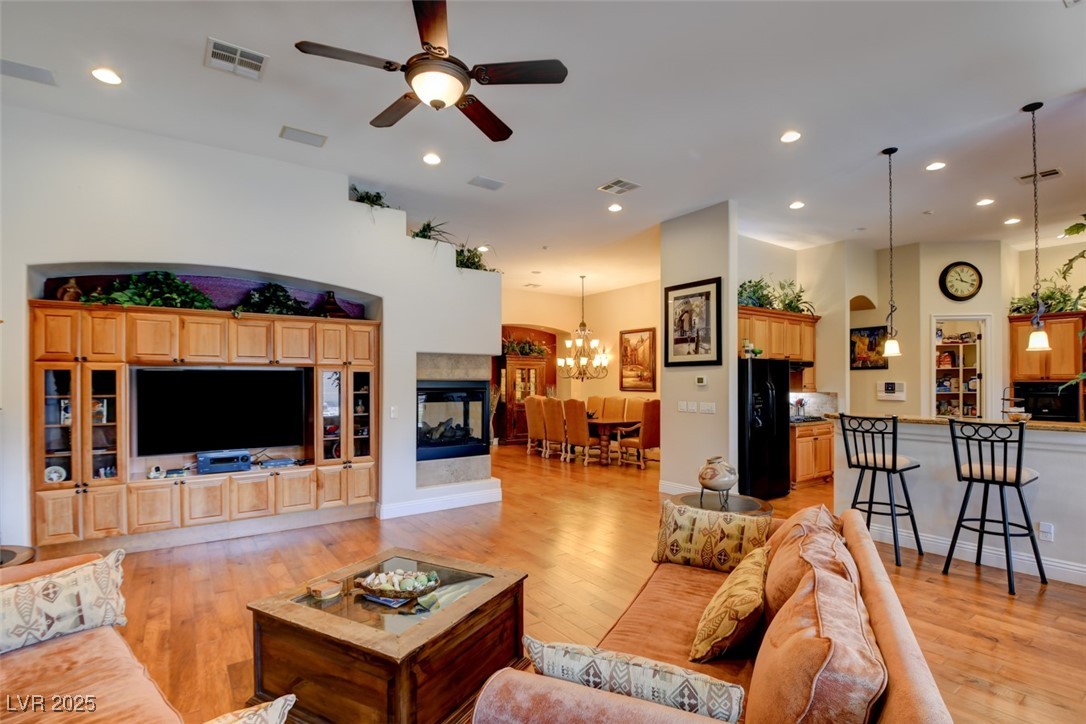 8465 West Picket Ridge Court Las Vegas, NV 89143 - Photo 12 of 51 Family room featuring a built-in entertainment center, opening to an airy and open living environment