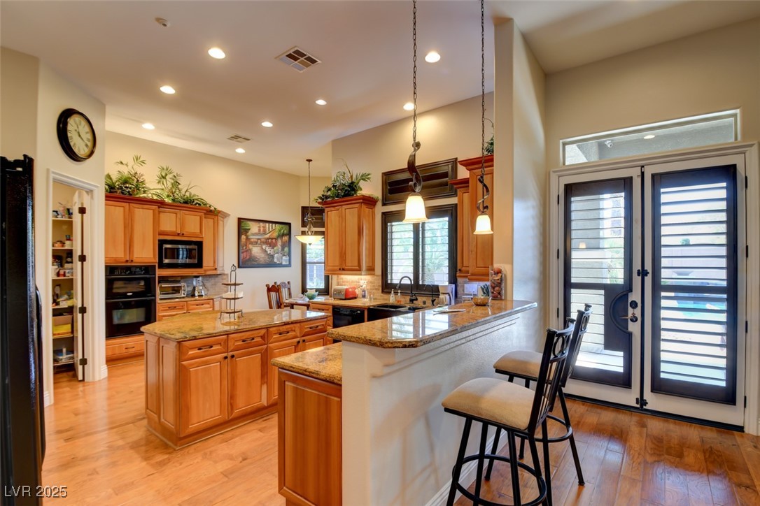 8465 West Picket Ridge Court Las Vegas, NV 89143 - Photo 14 of 51 Spacious kitchen with granite countertops and a large island