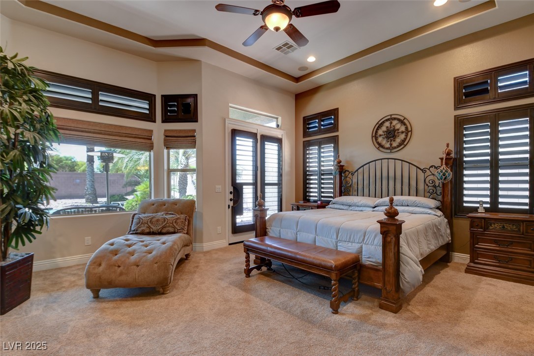 8465 West Picket Ridge Court Las Vegas, NV 89143 - Photo 19 of 51 Primary bedroom with elegant coffered ceilings and direct access to the backyard through a private entrance door
