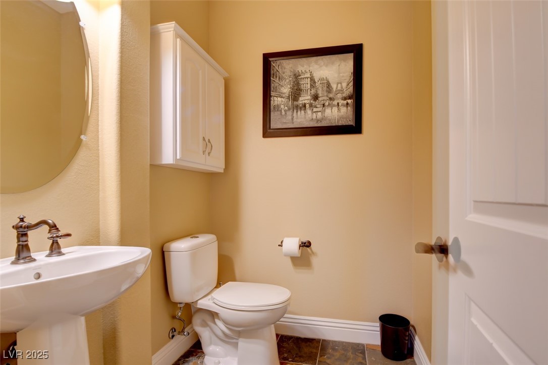 8465 West Picket Ridge Court Las Vegas, NV 89143 - Photo 32 of 51 Generously sized powder room featuring elegant pedestal sink