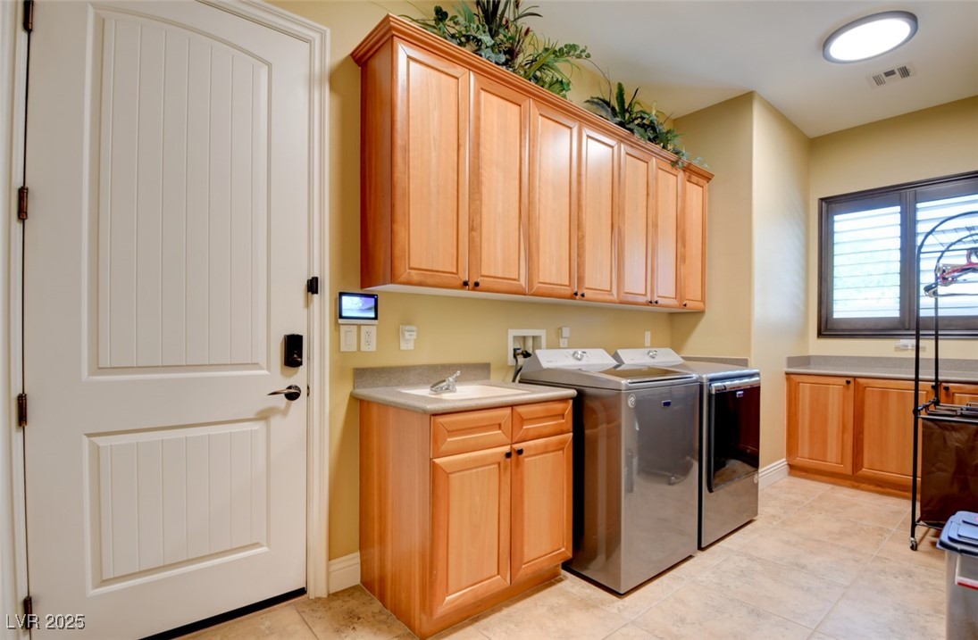 8465 West Picket Ridge Court Las Vegas, NV 89143 - Photo 39 of 51 Spacious laundry room with abundant cabinets, a sink, and included washer and dryer