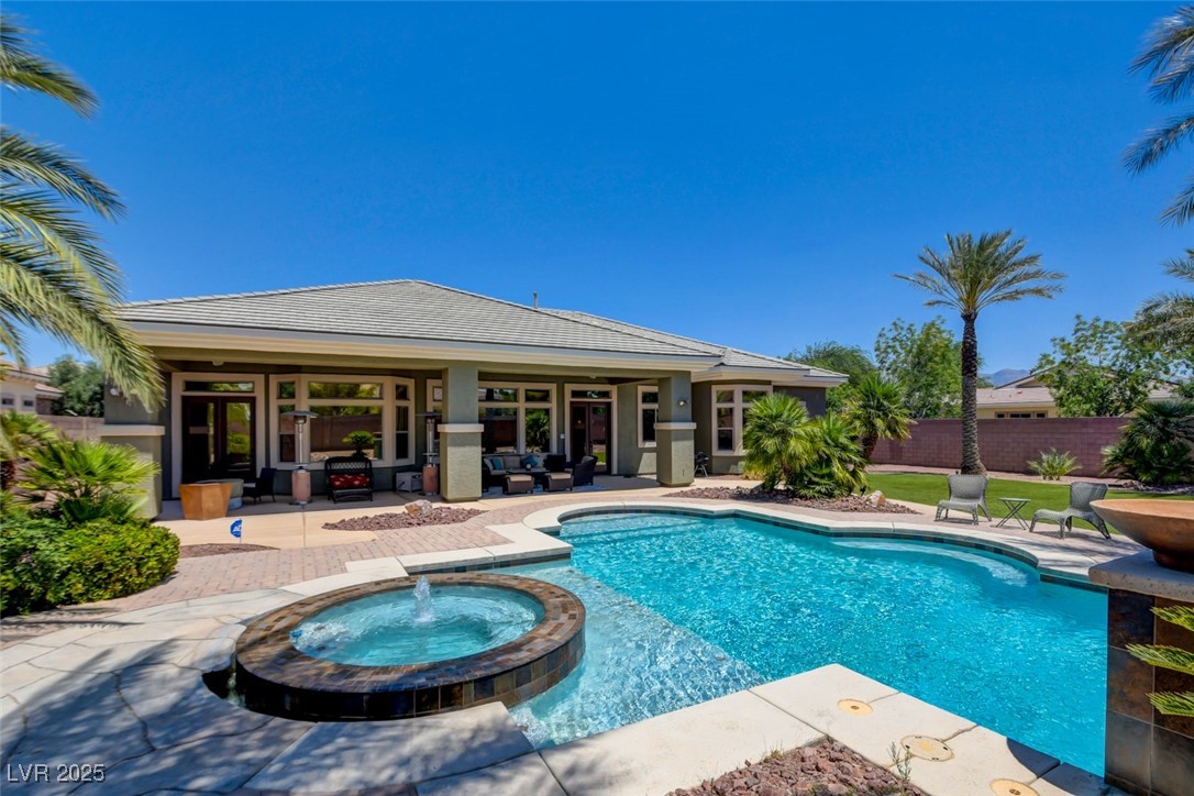 8465 West Picket Ridge Court Las Vegas, NV 89143 - Photo 47 of 51 Hot tub with water feature and heating for year-round enjoyment